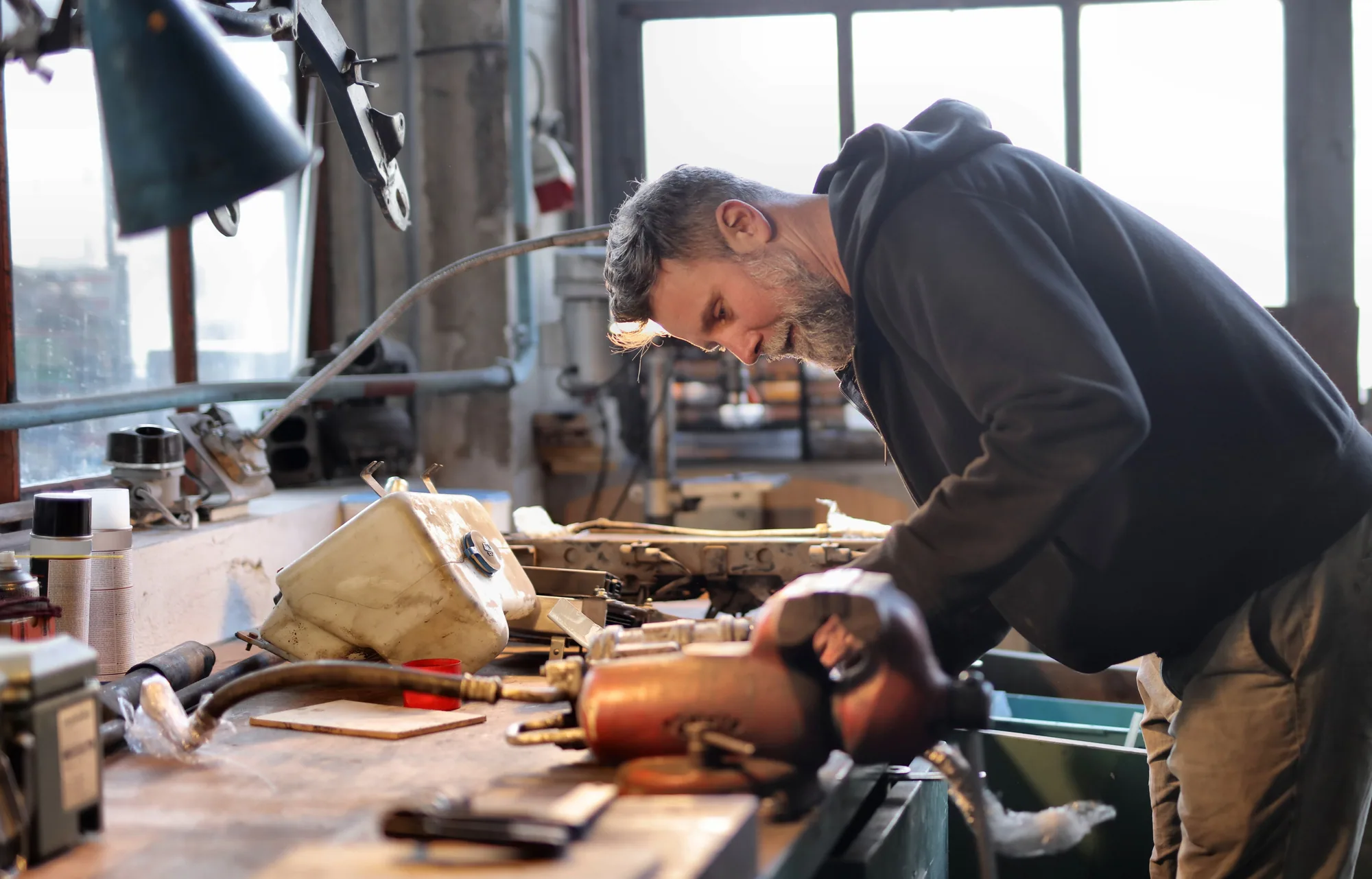 Craftsperson working carefully at a workshop bench