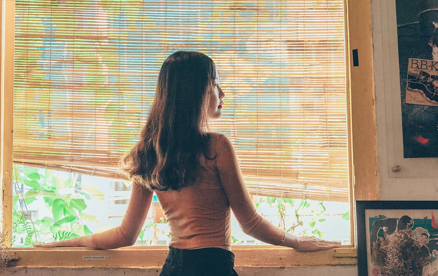Woman looking toward daylight by a window